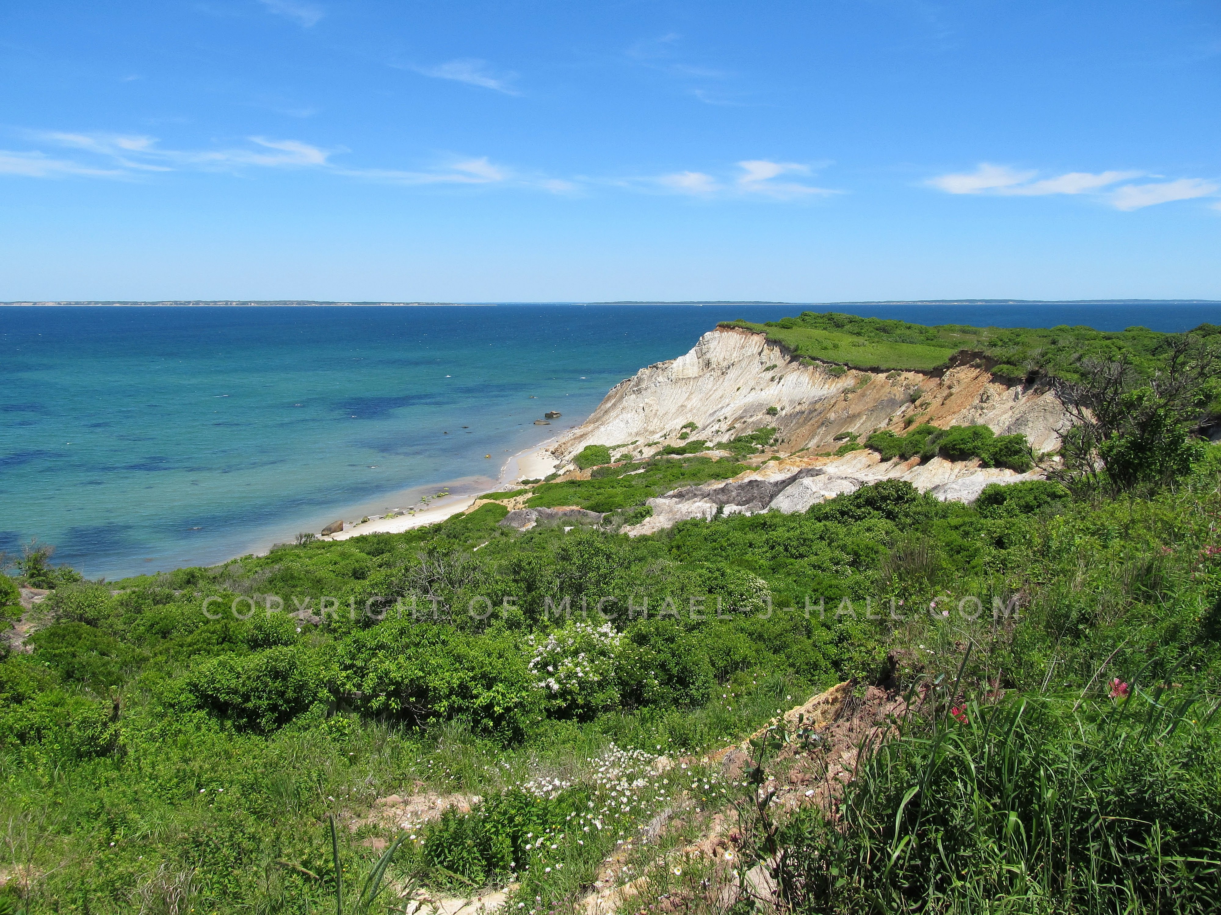 Tropical looking waters, calm and clear at the moment, lap gently at the sandy shores, yet slowly wash away the clay based "land under the hill" of the cliffs of Aquinnah, so named by the native Wampanoag people.